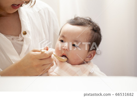 Baby eating baby food 66531682