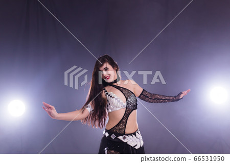 Young woman dancing in Tribal Fusion style. Belly dance on the stage. Young woman dancing in Tribal Fusion style. Belly dance on the stage. 66531950