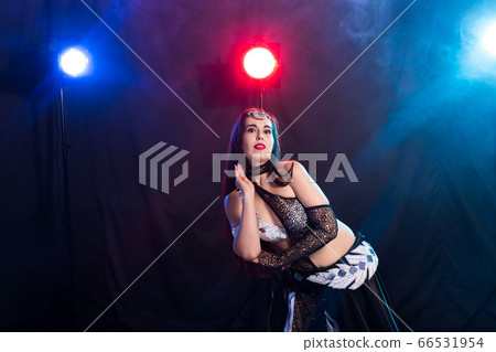 Young woman dancing in Tribal Fusion style. Belly dance on the stage. Young woman dancing in Tribal Fusion style. Belly dance on the stage. 66531954