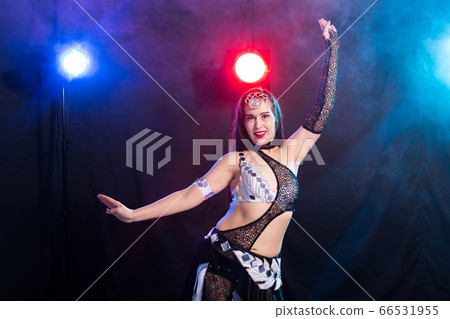 Spirituality dance. Beautiful sexy woman with luxury glossy eastern make-up dancing tribal fusion. Belly dance. Spirituality dance. Beautiful sexy woman with luxury glossy eastern make-up dancing tribal fusion. Belly dance. 66531955