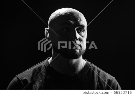 Black and white photo of the bald man on black background 66533716