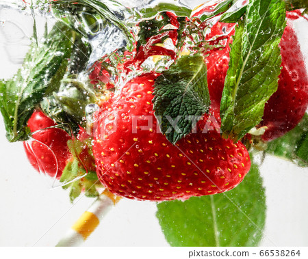 Close up view of the cold and fresh lemonade with bright berries in neon light 66538264