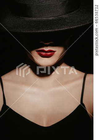 stylish Studio portrait of a girl in a black hat and dress stylish Studio portrait of a girl in a black hat and dress 66538712