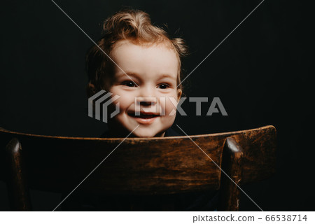 face of a happy smiling Caucasian child boy on a dark background face of a happy smiling Caucasian child boy on a dark background 66538714