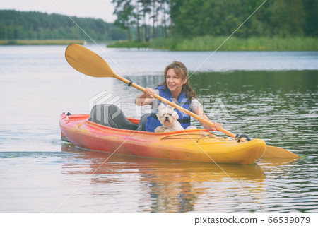 Woman and her dog on a kayak 66539079