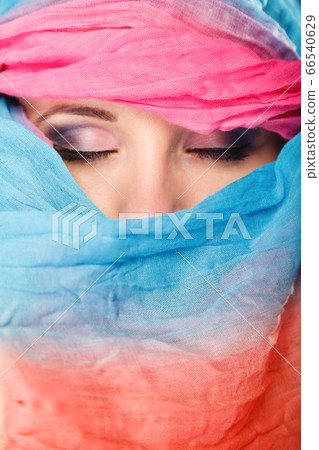 woman makeup on eyes hiden her face with shawl woman makeup on eyes hiden her face with shawl 66540629