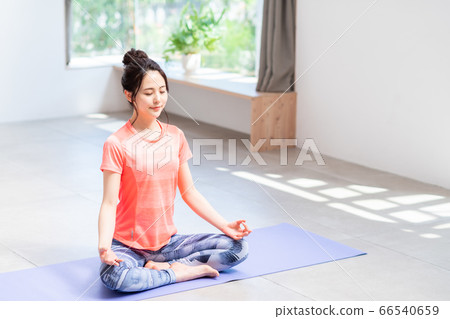 Young woman doing yoga at home 66540659