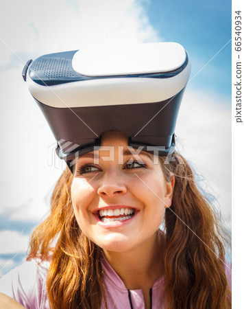 Woman wearing VR outside 66540934
