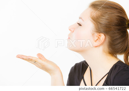 Happy woman sending air kisses Happy woman sending air kisses 66541722