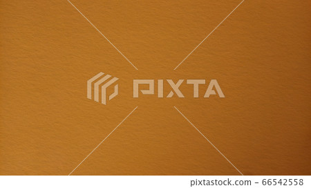 Ocher color background. Colored paper dimly lit in the middle. Light dark vignetting around the edges. The play of light and shadow. Can be used as background. Light vignetting, darker on the right 66542558