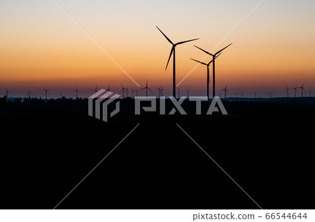 Black Silhouette of windturbines energy generator on amazing sunset at a wind farm in germany Black Silhouette of windturbines energy generator on amazing sunset at a wind farm in germany 66544644