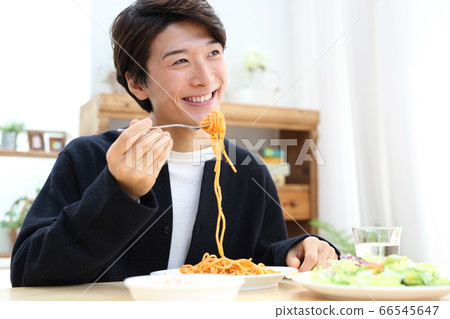 Image of young man eating at home Image of young man eating at home 66545647