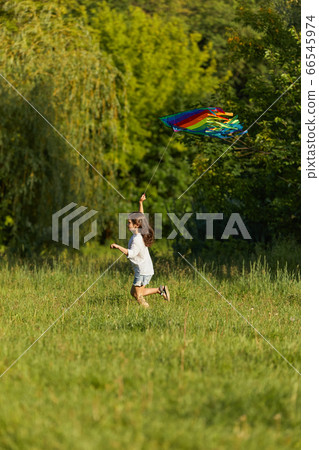 happy cute little child girl launches kite 66545974