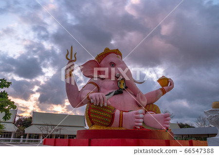 pink Ganesha statue in purple sunrise 66547388