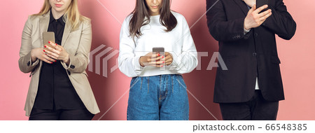 Group of friends using mobile smartphones. Teenagers addiction to new technology trends. Close up. Group of friends using mobile smartphones. Teenagers addiction to new technology trends. Close up. 66548385