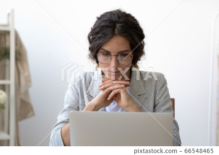 Young Caucasian woman watch webinar on laptop Young Caucasian woman watch webinar on laptop 66548465