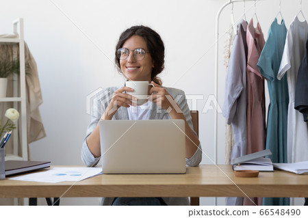 Smiling female drink coffee look in distance dreaming Smiling female drink coffee look in distance dreaming 66548490