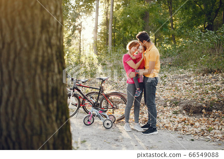 Family with a bicycle in a summer park Family with a bicycle in a summer park 66549088
