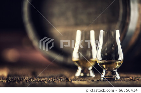 Two Glencairn whisky tasting glasses on vintage 66550414