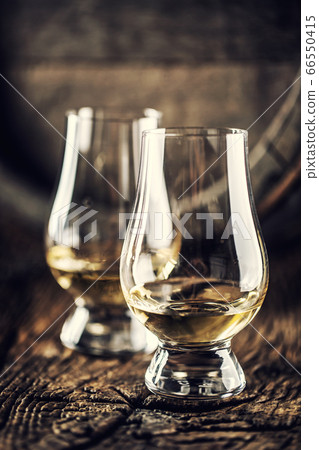 Two Glencairn whisky tasting glasses on vintage 66550415