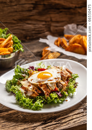 Chicken salad with sunny side up egg and sauce on Chicken salad with sunny side up egg and sauce on 66550475