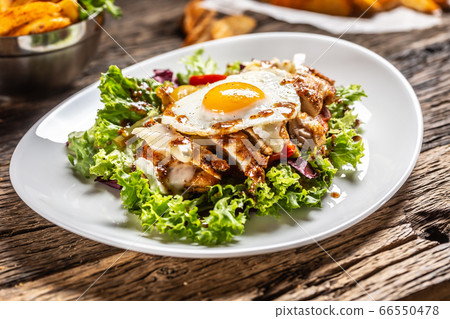 Chicken salad with sunny side up egg and sauce on Chicken salad with sunny side up egg and sauce on 66550478
