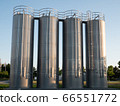 Four stainless steel silos shot in the morning sun with a clear blue sky 66551772