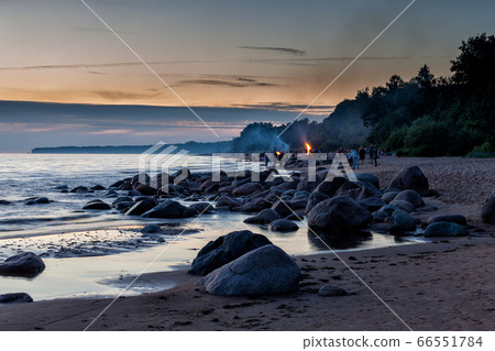 Unrecognisable people celebrating summer solstice with bonfires on beach Unrecognisable people celebrating summer solstice with bonfires on beach 66551784