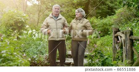Happy senior woman and man in park Happy senior woman and man in park 66551886