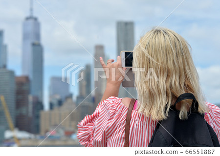 Woman taking picture New York city skyline Woman taking picture New York city skyline 66551887