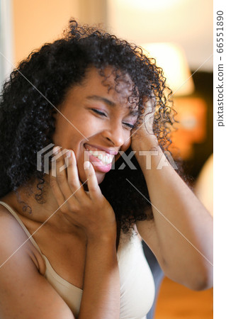 Portrait of cute black girl sitting in room and wearing beige lingerie. Portrait of cute black girl sitting in room and wearing beige lingerie. 66551890