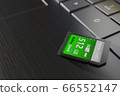 High capacity memory card on laptop close-up. SDXC 512 gb. Modern storage devices concept. Top angle view. Keyboard buttons in frame. Selective focus. 3D render 66552147