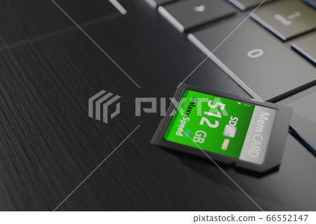High capacity memory card on laptop close-up. SDXC 512 gb. Modern storage devices concept. Top angle view. Keyboard buttons in frame. Selective focus. 3D render 66552147