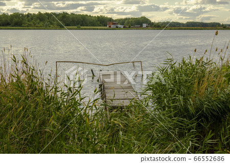 View through the reeds to the old fishing bridge. 66552686