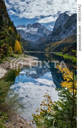 Peaceful autumn Alps mountain lake with clear Peaceful autumn Alps mountain lake with clear 66553442