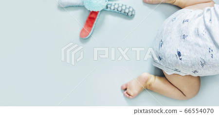 Baby boy crawling with toy Baby boy crawling with toy 66554070