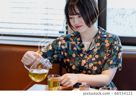 Woman eating cake at a cafe 66554121