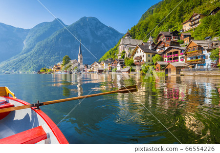 Classic view of Hallstatt with traditional rowing boat in summer, Austria Classic view of Hallstatt with traditional rowing boat in summer, Austria 66554226