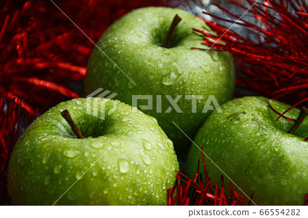 Triple fresh green apples with water drops on them 66554282