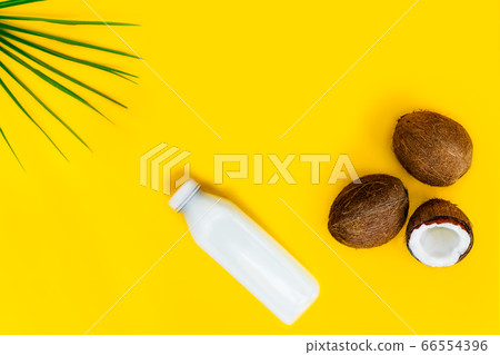 Top view bottle of fresh raw vegan coconut milk Top view bottle of fresh raw vegan coconut milk 66554396
