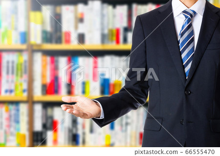 Businessman and bookshelf Businessman and bookshelf 66555470