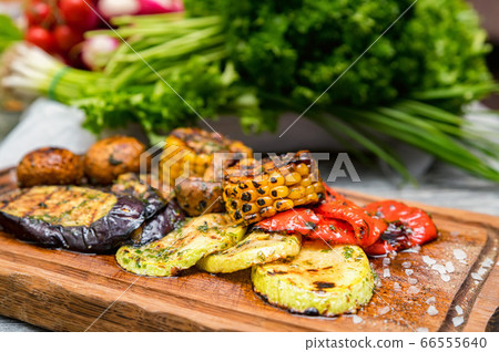 Various tasty grilled vegetables and mushrooms on rustic background Various tasty grilled vegetables and mushrooms on rustic background 66555640
