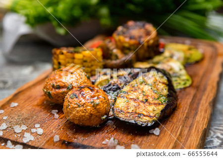 Various tasty grilled vegetables and mushrooms on rustic background 66555644