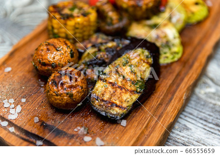 Various tasty grilled vegetables and mushrooms on rustic background Various tasty grilled vegetables and mushrooms on rustic background 66555659