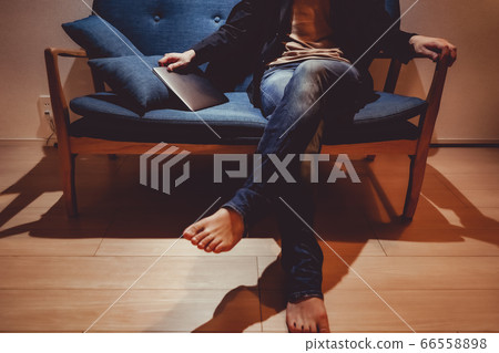 A man sitting on a fashionable sofa 66558898