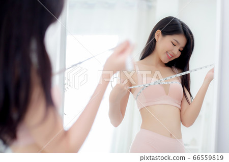 Beautiful young asian woman sexy body slim measuring breast for control weight loss. 66559819
