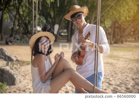 Happy young honeymoon couple on beach having Happy young honeymoon couple on beach having 66560000