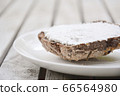 brown bread with cheese cream on a white plate 66564980