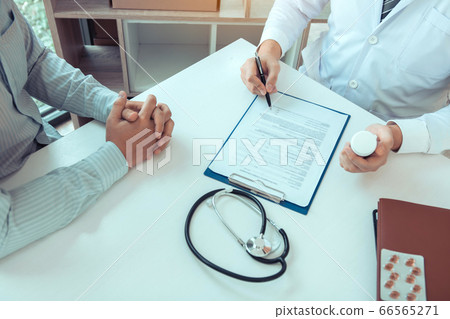 Asian male doctor hand holding pen writing patient 66565271