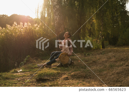 Mother and baby girl sitting near lake. Local travel. New normal vacation. Mother's day Mother and baby girl sitting near lake. Local travel. New normal vacation. Mother's day 66565623